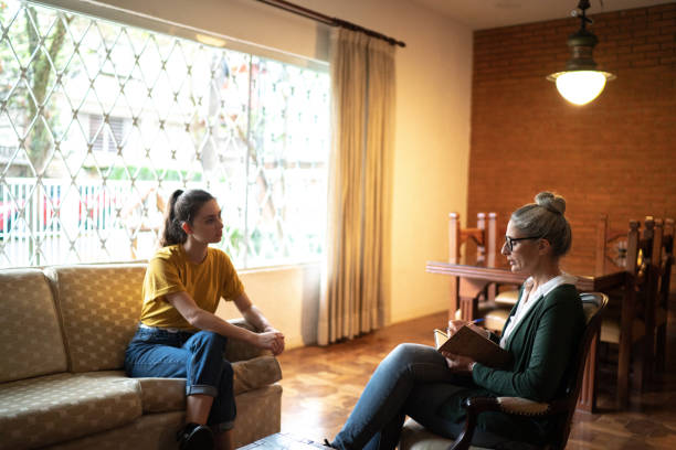 Young woman in therapy with a psychotherapist at home