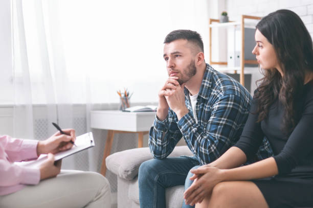 Family crisis. Young grumpy couple at marital counseling therapy, free space